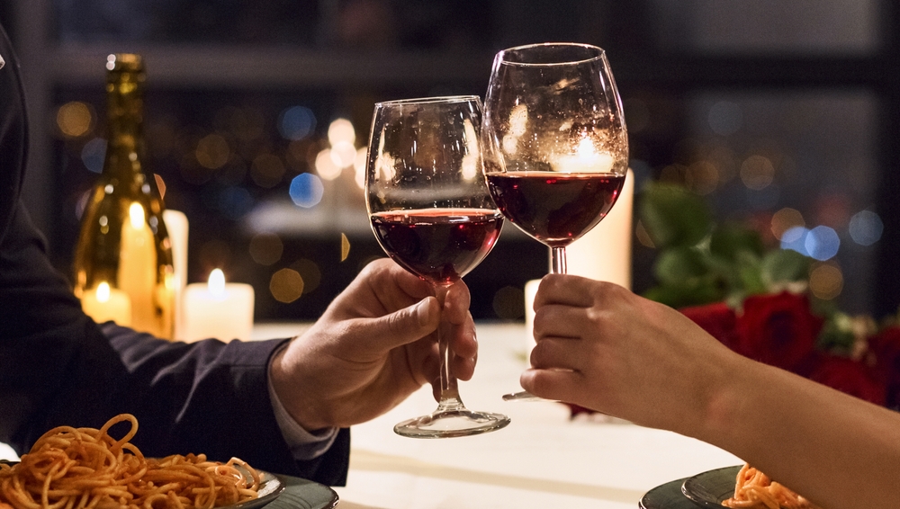 Couple enjoying wine and a romantic meal at foodie spots like Primo Restaurant in Rockland, Maine