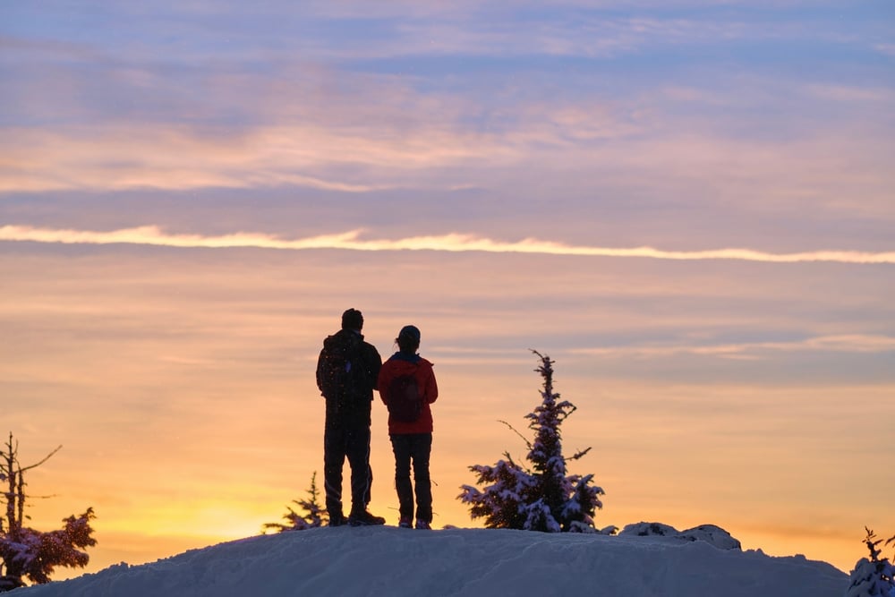 Couple snowshoeing at dusk near Parfrey's Glen and our Wisconsin Bed and Breakfast